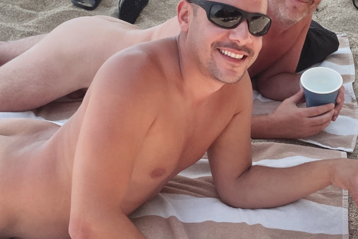 a group of people sitting at a beach