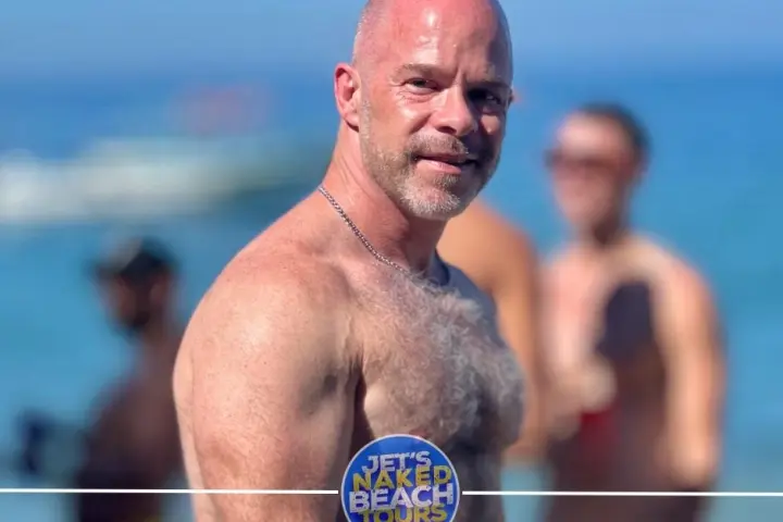 a man standing in front of water