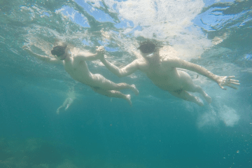 a person riding a wave on top of a body of water